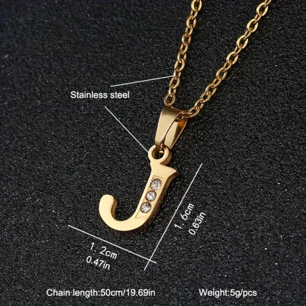 The Stainless Steel Letter Necklace showcases a pendant shaped like the letter "J," adorned with three small diamonds. The pendant dimensions are 1.2 cm (0.47 inches) by 1.6 cm (0.63 inches), weighing 5 grams and made from durable stainless steel. The necklace features a gold chain with a length of 50 cm (19.69 inches).