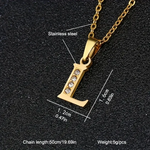 A close-up image of the Stainless Steel Letter Necklace showcases a gold-colored "L" pendant adorned with four small crystals, measuring 1.6 cm (0.63 in) in height and 1.2 cm (0.47 in) in width. The necklace features a 50 cm (19.69 in) chain and weighs 5g per piece.