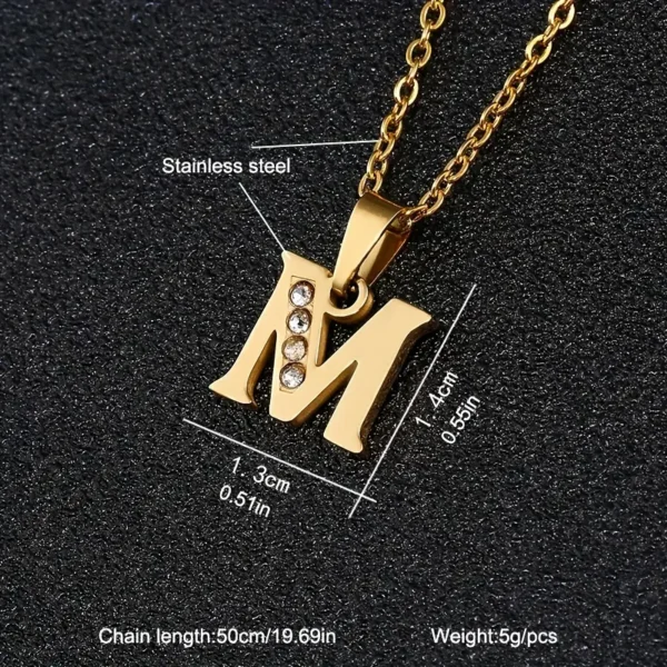 Stainless Steel Letter Necklace featuring a gold-colored finish and an "M" pendant adorned with small rhinestones on the left side. The pendant measures 1.4 cm by 1.3 cm, weighs 5g, and is accompanied by a chain that is 50 cm (19.69 in) long.