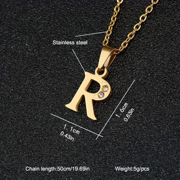 The Stainless Steel Letter Necklace is an elegant piece featuring a gold-colored stainless steel pendant in the shape of "R," adorned with a small embedded crystal. The pendant measures 1.6 cm in height and 1.1 cm in width, while the chain is 50 cm (19.69 inches) long and weighs just 5 grams.