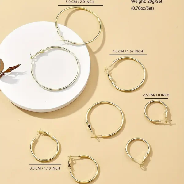 A display of the 4 Pair Hoop Earrings Set: Minimalist, Stainless Steel, Everyday Chic arranged on a beige surface. The hoops, perfect for any occasion, vary in size with measurements in centimeters (CM) and inches written above each pair, ranging from 5.0 CM / 2.0 inches to 2.5 CM / 1.0 inch.