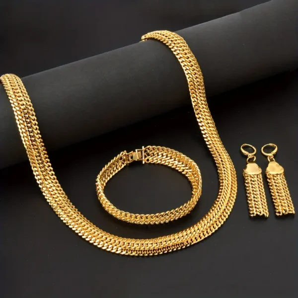 The Hip Hop Miami Cuban Necklace and Bangle Earrings Set, featuring a thick Miami Cuban necklace, a matching bracelet, and a pair of dangling earrings with intricate chain designs, is displayed on a black surface with a black cylindrical prop.