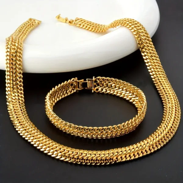 A striking set of gold jewelry displayed on a black and white background. This Hip Hop Miami Cuban Necklace and Bangle Earrings Set includes a thick Miami Cuban necklace and matching bangle earrings, both featuring a classic curb link design with a polished, reflective finish, perfect for unisex fashion enthusiasts.