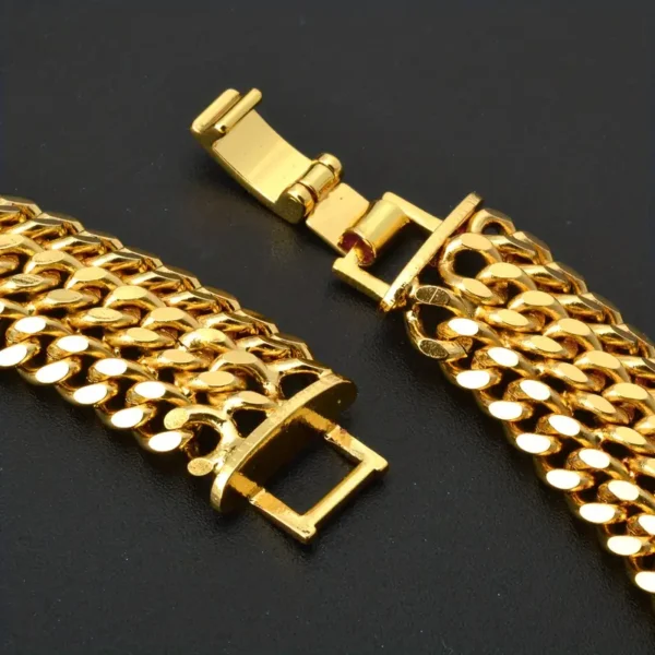 A close-up of the Hip Hop Miami Cuban Necklace from the Bangle Earrings Set features a gold chain bracelet with a box clasp, showcasing meticulous craftsmanship characteristic of unisex fashion jewelry. The necklace boasts a shiny, reflective surface and an intricate link design. The box clasp, shown open, appears to be in excellent condition against a dark background.