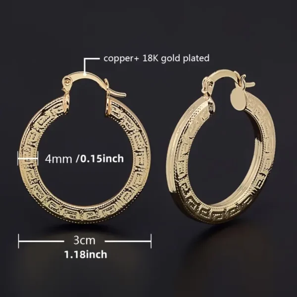 Displayed against a black background, the Elegant 14K Gold Plated Hoop Earrings with Great Wall Print feature intricate designs. One earring lies flat while the other is upright, showcasing its clasp. The earrings measure 4 mm (0.15 inch) in width and have a diameter of 3 cm (1.18 inch).