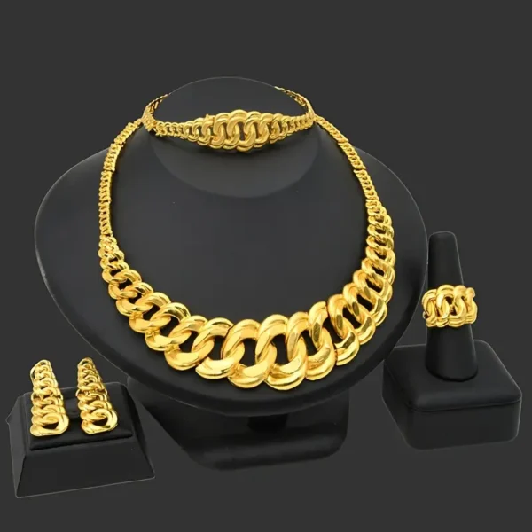 The Chunky Gold Necklace Jewelry Set: Bridal, Wedding, & Party Glam is made of thick gold chains and includes a chunky gold necklace, a bracelet, a ring, and a pair of earrings, all featuring an interlocking link design. Displayed on a black stand, the dark gray background makes the bright gold of the jewelry stand out beautifully.