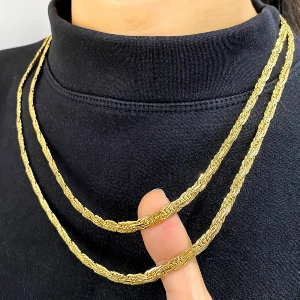 A person wearing a black turtleneck showcases two Golden Chain 0.2inch Wide Long Geometric Necklaces, reminiscent of a dainty gold necklace gift. The chains are being gently held and displayed with the person's fingers, highlighting their intricate design.