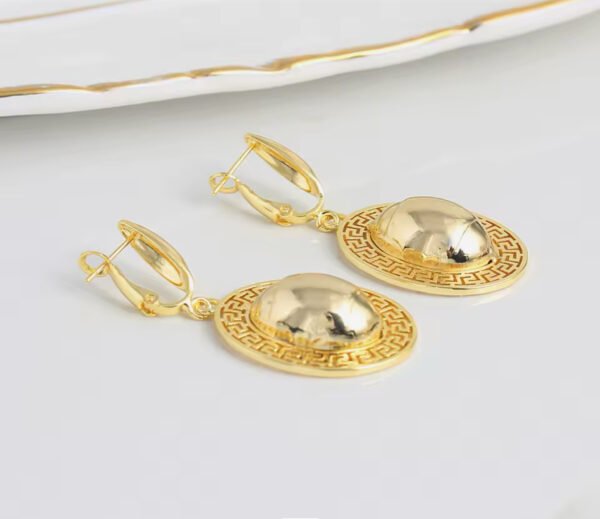 a pair of gold earrings