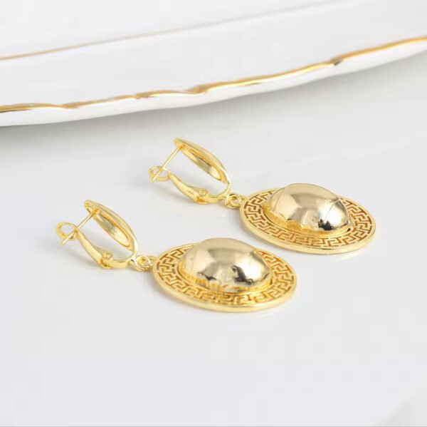 a pair of gold earrings