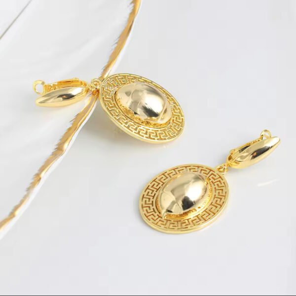 a pair of gold earrings