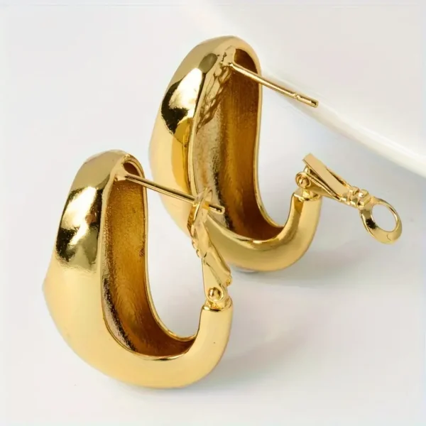 a pair of gold earrings