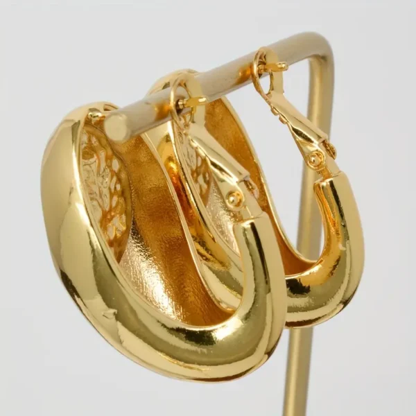 a pair of gold earrings