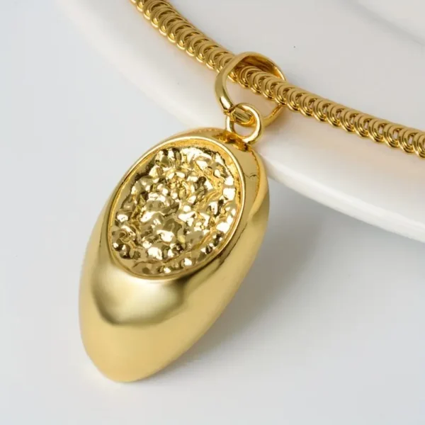 a gold necklace with a pendant on it