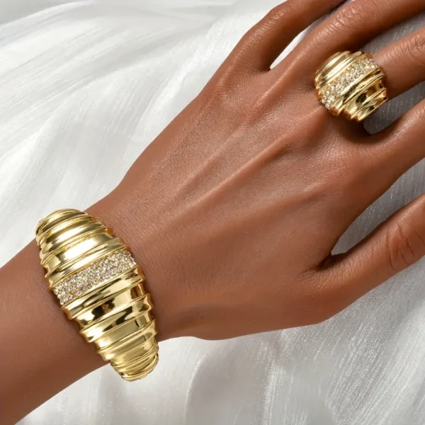 a hand with gold rings and bracelets